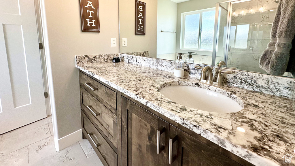 Bathroom featuring vanity and a shower stall