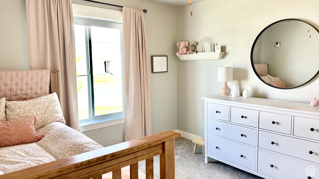 Bedroom featuring light carpet and baseboards