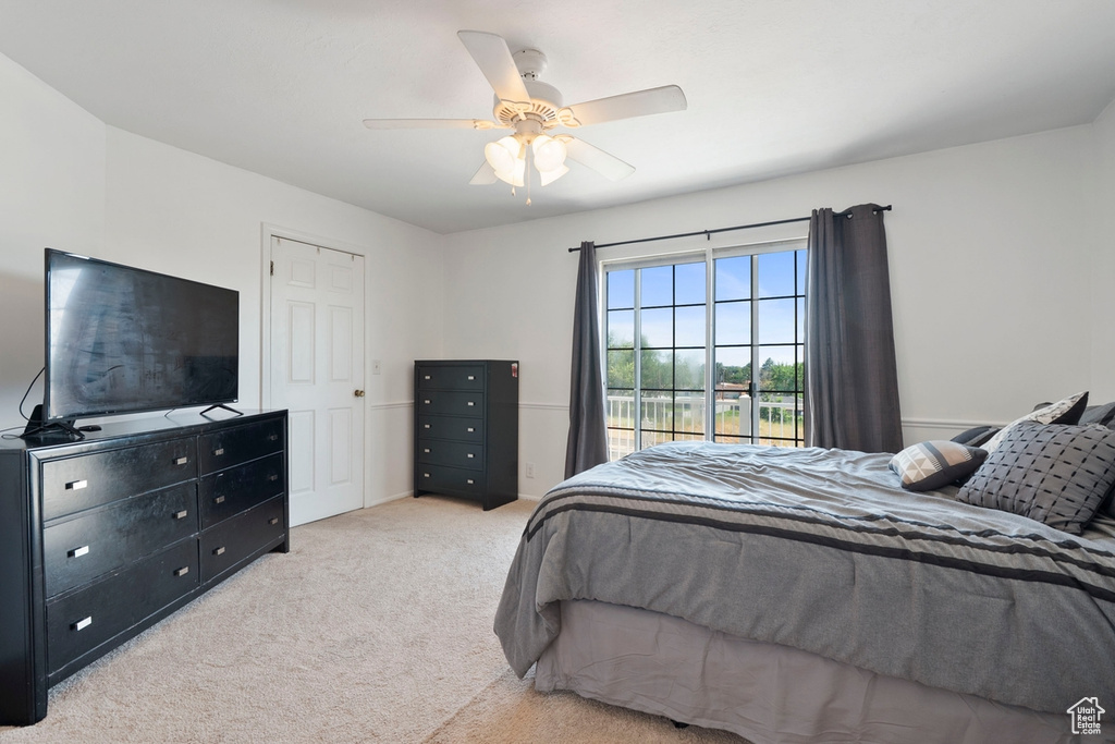 Carpeted bedroom with ceiling fan