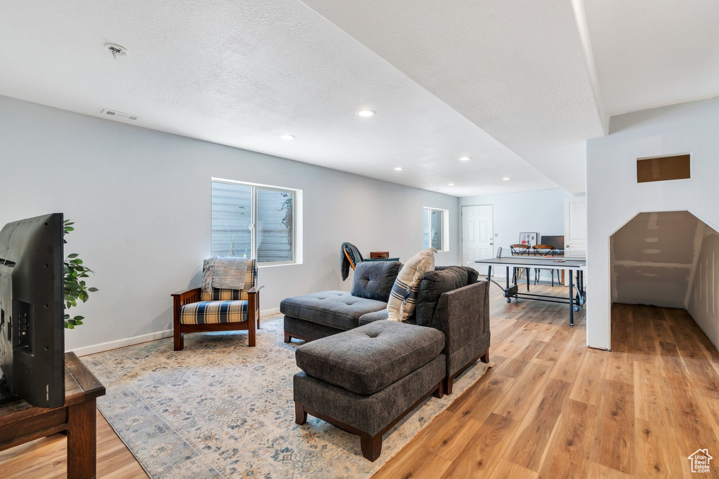 Living area featuring light wood-style floors, recessed lighting, plenty of natural light, and baseboards