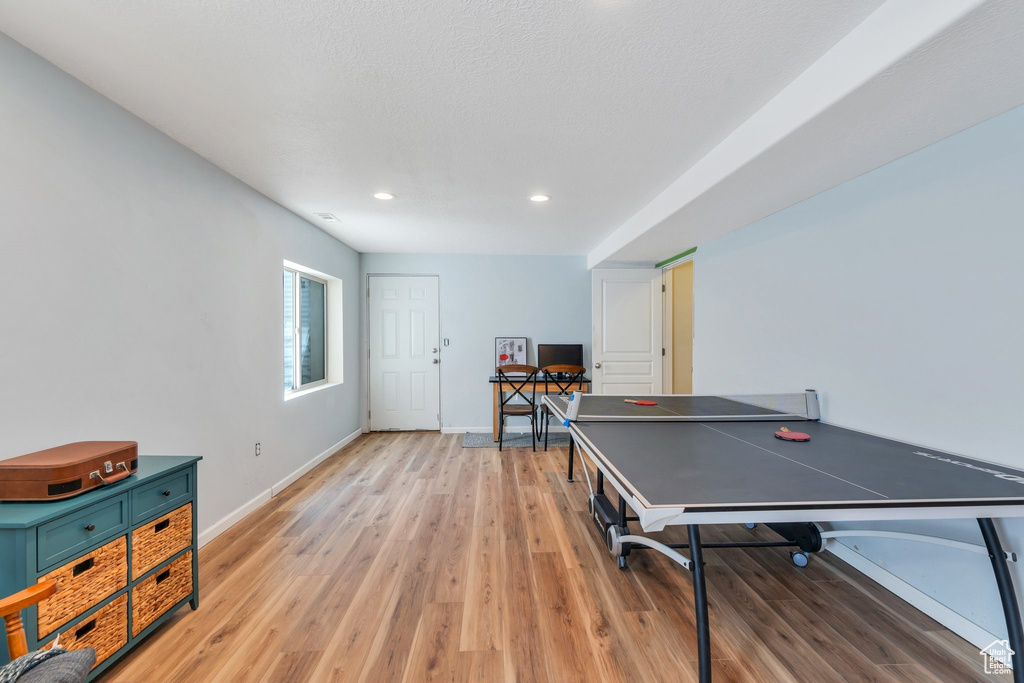 Recreation room featuring light wood finished floors, recessed lighting, and baseboards