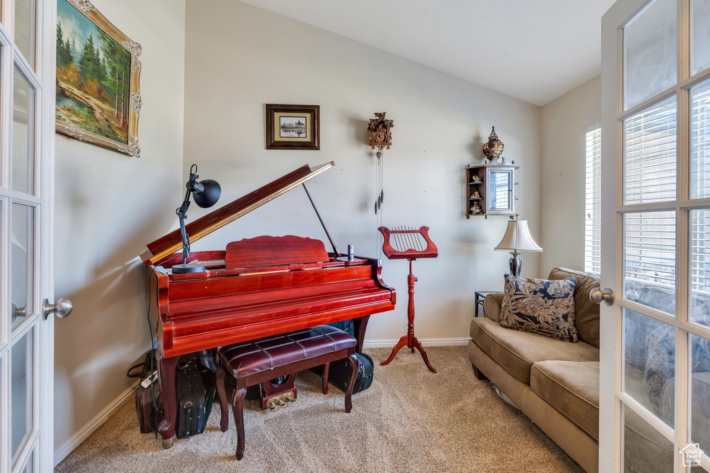 Living area featuring carpet flooring and baseboards