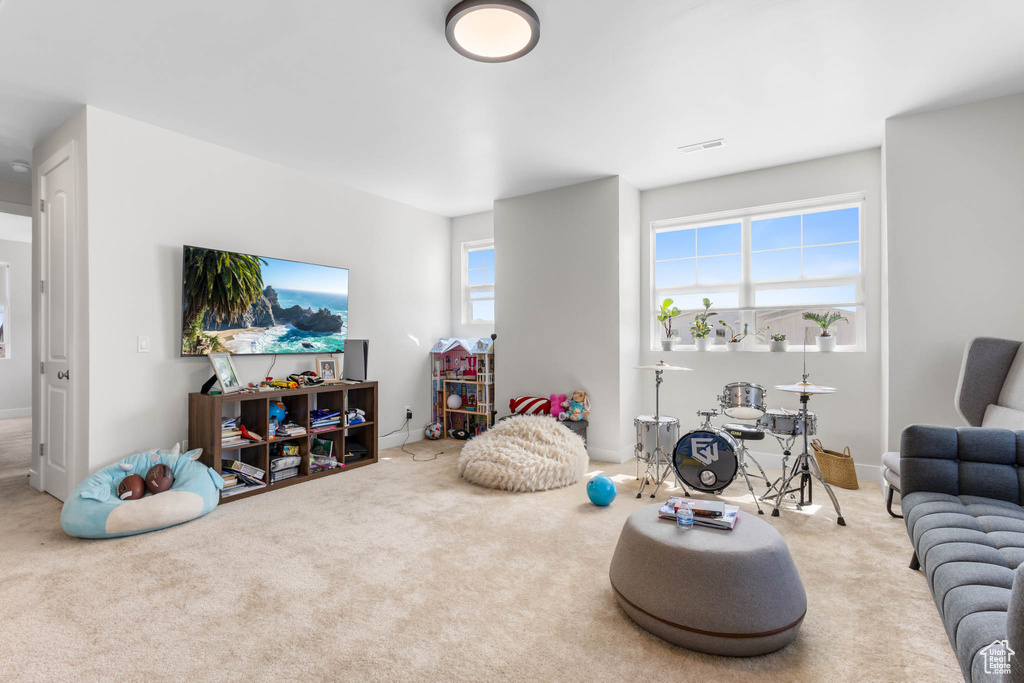 Carpeted living area featuring baseboards