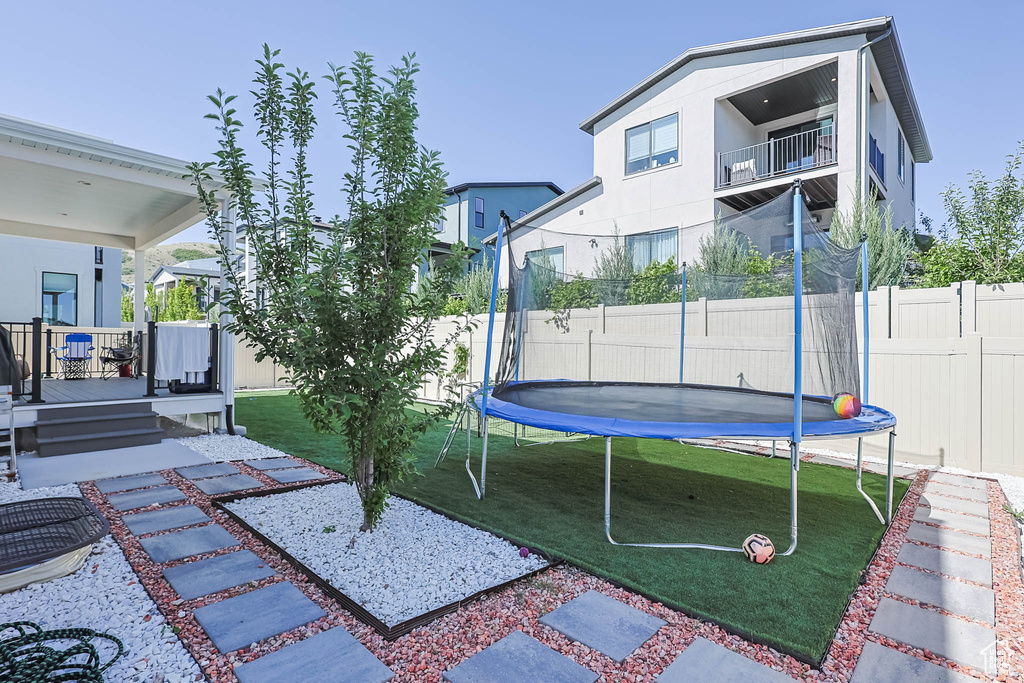 View of yard featuring a trampoline