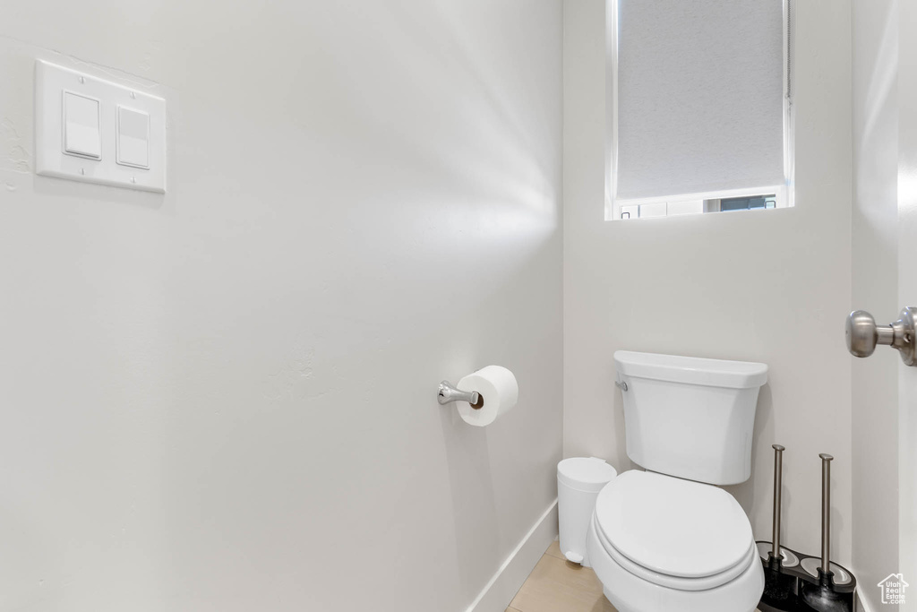Bathroom with toilet and baseboards