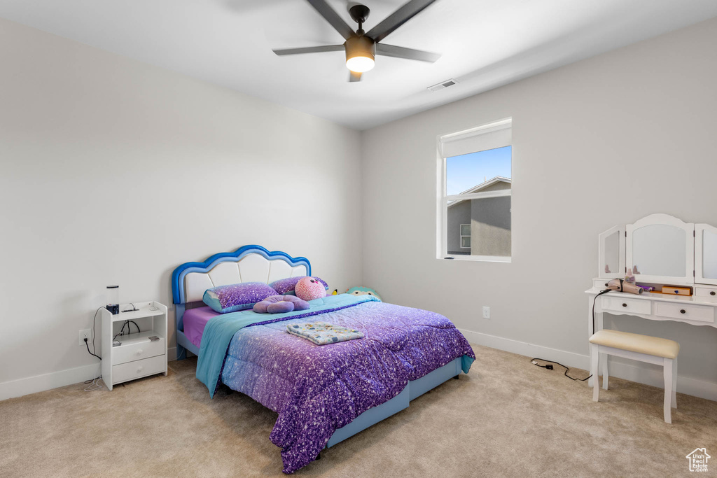 Carpeted bedroom with baseboards and ceiling fan