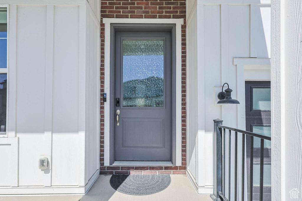 Entrance to property with brick siding and board and batten siding