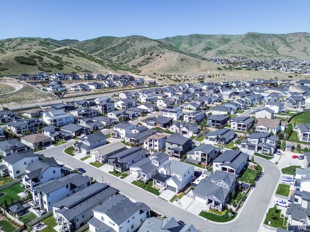 Aerial overview of property's location with nearby suburban area and a mountain backdrop