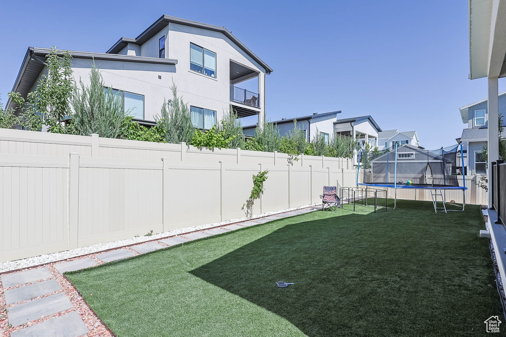 View of yard with a trampoline