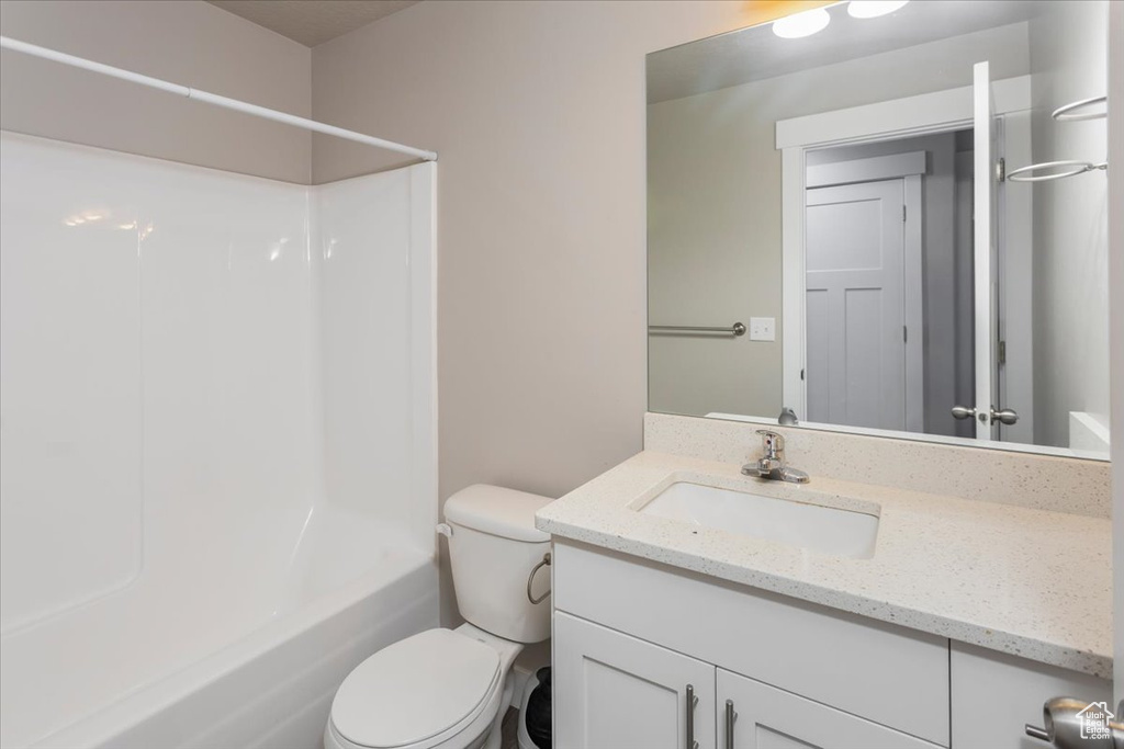 Full bath featuring vanity, toilet, and shower / tub combination