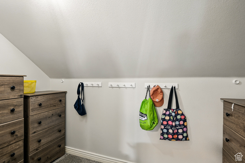 Bathroom featuring vaulted ceiling and baseboards