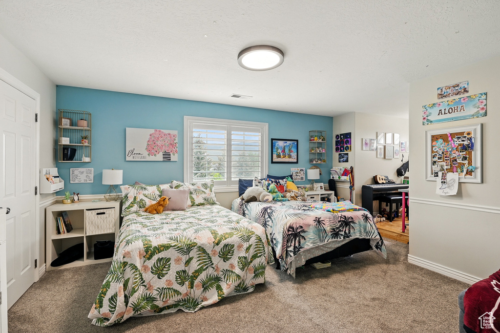 Bedroom featuring carpet and baseboards