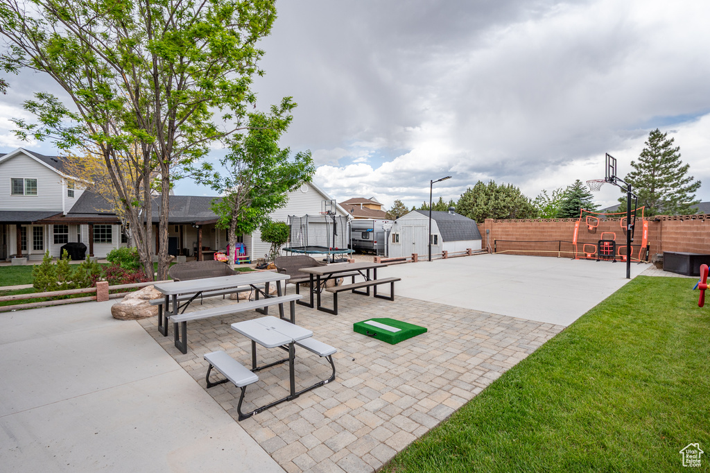 View of home's community featuring a trampoline and a patio