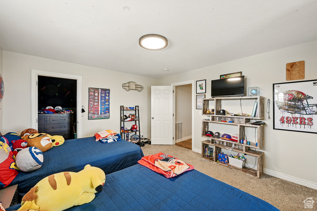 Bedroom with carpet flooring and baseboards