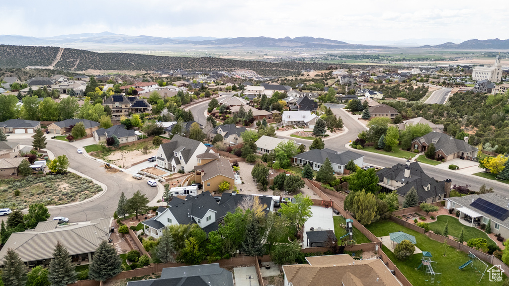 Aerial view of property's location featuring nearby suburban area and mountains