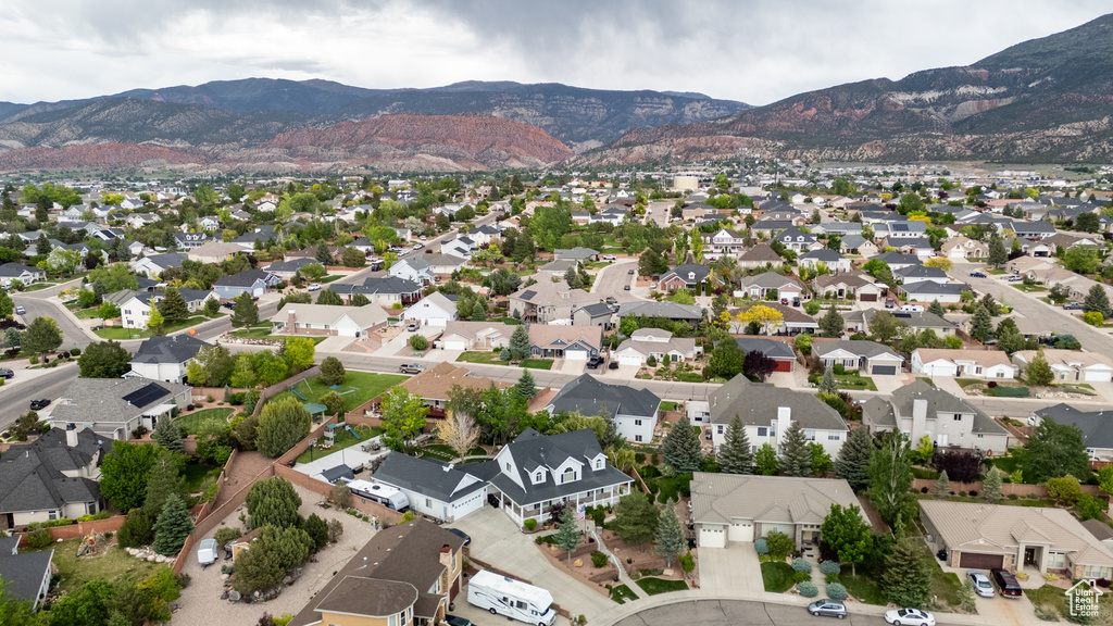 Aerial overview of property's location featuring mountains and nearby suburban area
