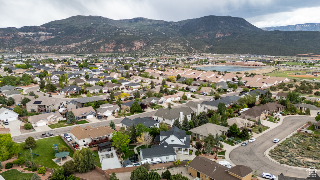 Aerial overview of property's location with mountains and nearby suburban area
