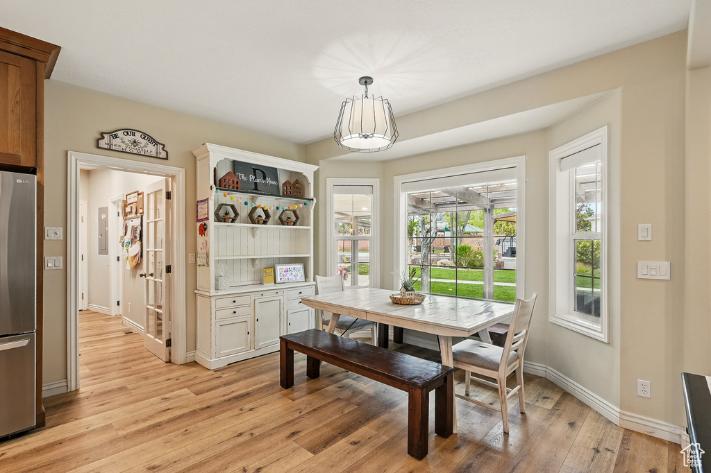 Dining area with light wood finished floors and baseboards