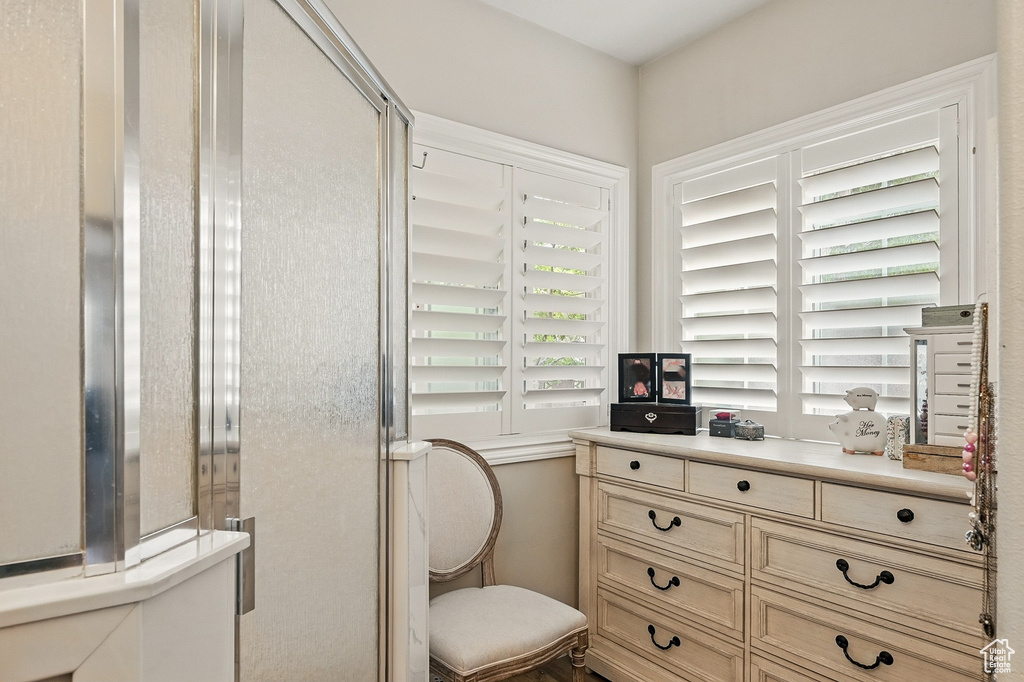 Full bathroom featuring toilet and a shower stall