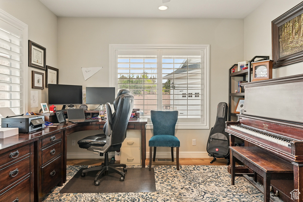 Home office with wood finished floors, baseboards, and recessed lighting
