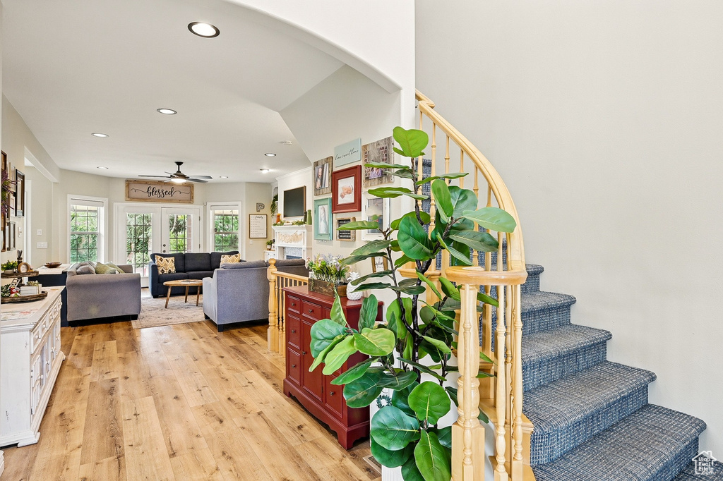 Stairs featuring wood finished floors, ceiling fan, and recessed lighting