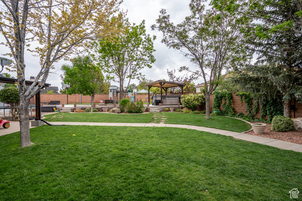 View of community with a gazebo and a hot tub