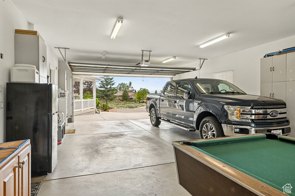 Garage featuring freestanding refrigerator