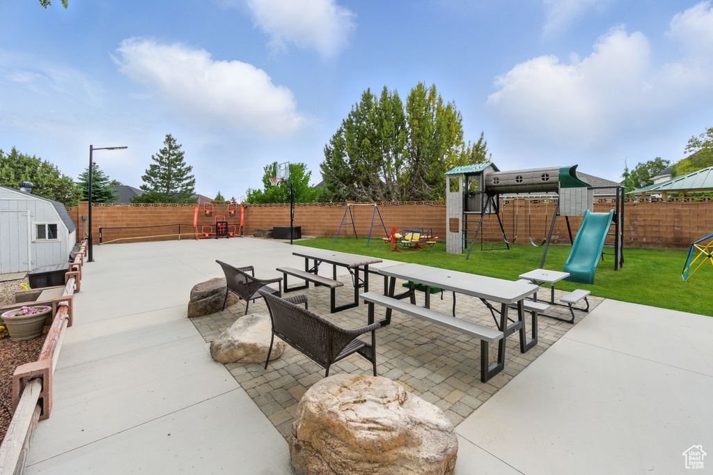 View of patio / terrace with a playground and a shed