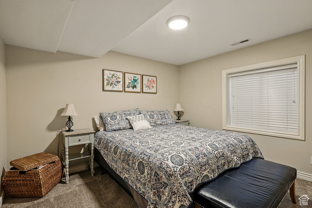 Carpeted bedroom featuring baseboards