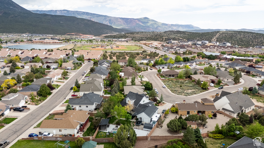 Aerial view of property's location with nearby suburban area and a mountainous background