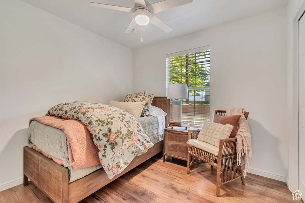 Bedroom with wood finished floors, baseboards, and ceiling fan