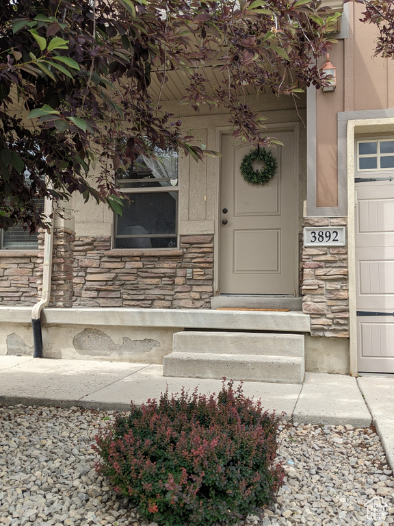 Entrance to property with stone siding