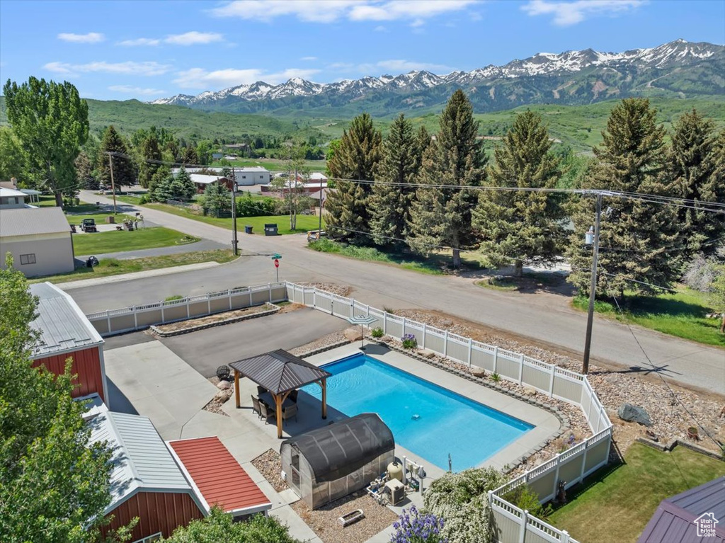 View of pool with a fenced backyard and a mountain view
