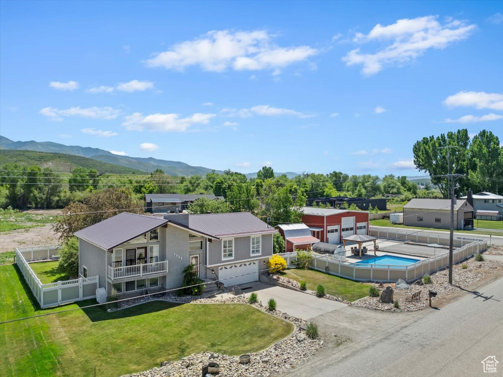 View from above of property with mountains and a pool