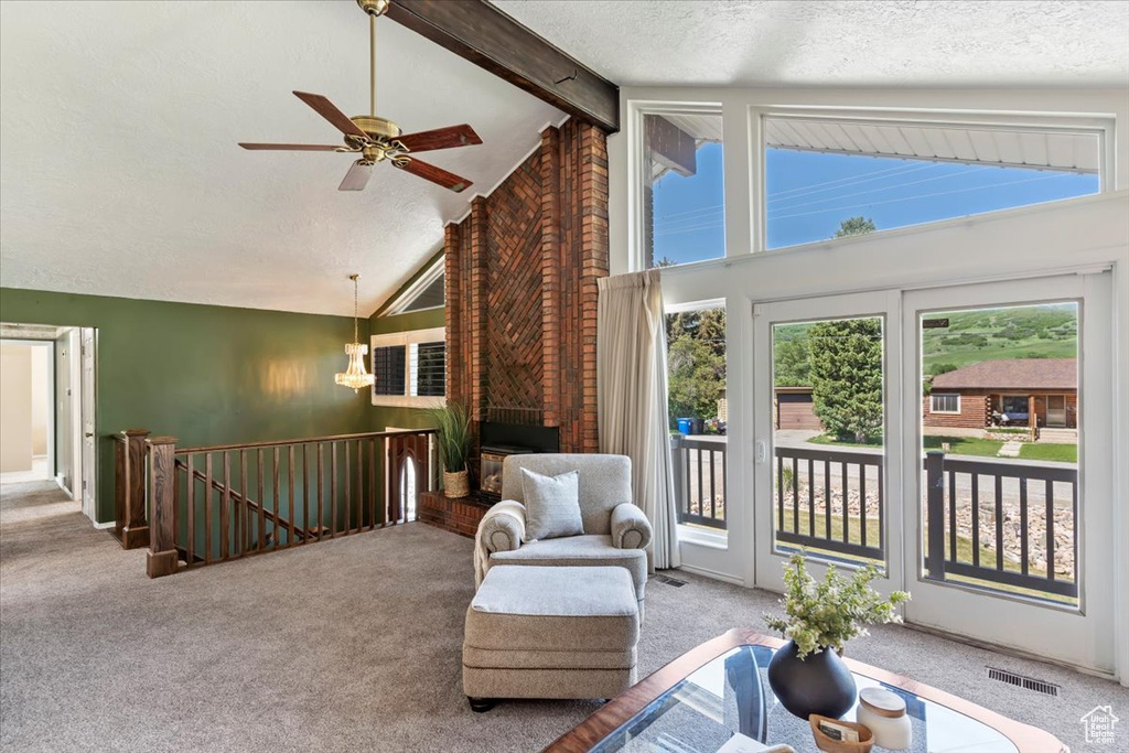 Sitting room with carpet, an upstairs landing, a ceiling fan, beam ceiling, and high vaulted ceiling