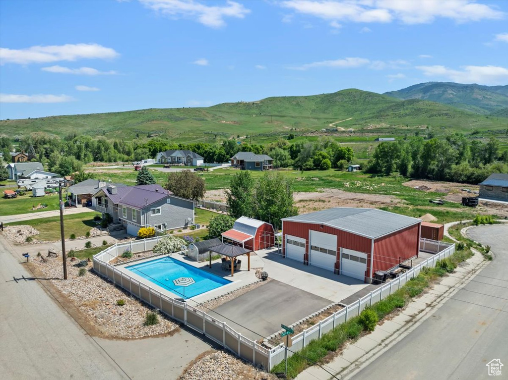 Drone / aerial view of a mountain backdrop and a pool