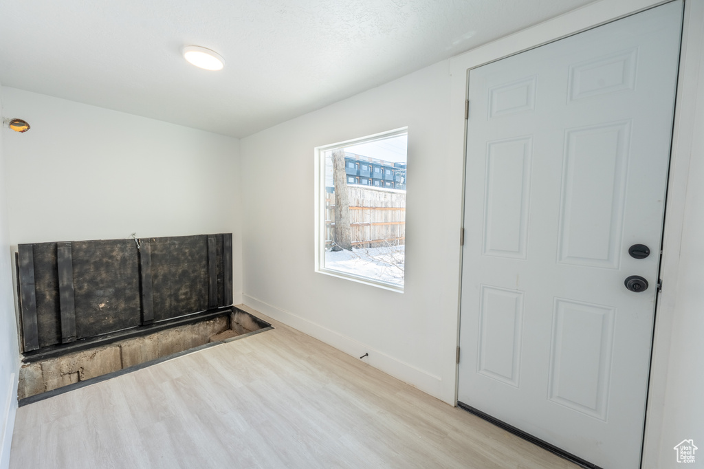 Unfurnished room with wood finished floors and baseboards