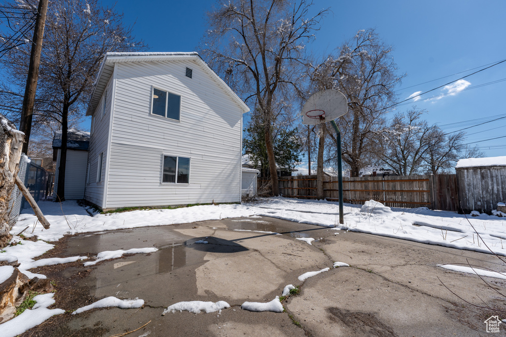 View of snow covered back of property