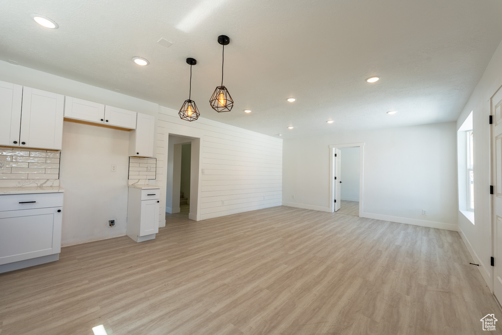 Unfurnished living room with light wood-style floors and recessed lighting