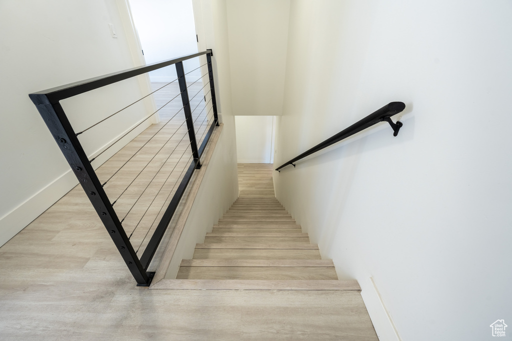 Stairway with wood finished floors