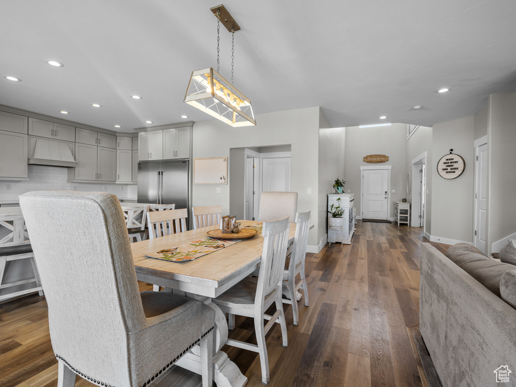 Dining space with recessed lighting, dark wood finished floors, and baseboards