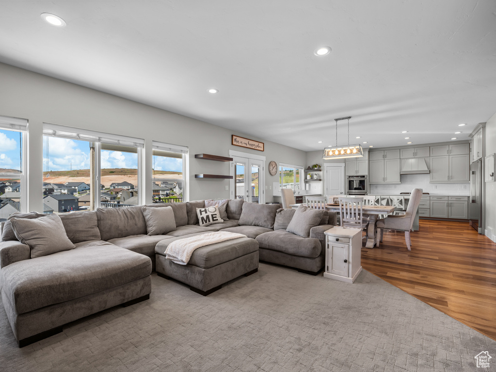 Living room with healthy amount of natural light, recessed lighting, and wood finished floors