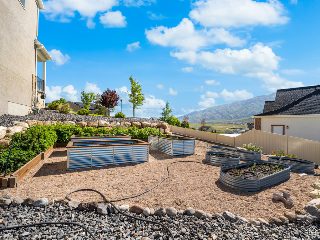 View of yard featuring a vegetable garden and a mountain view