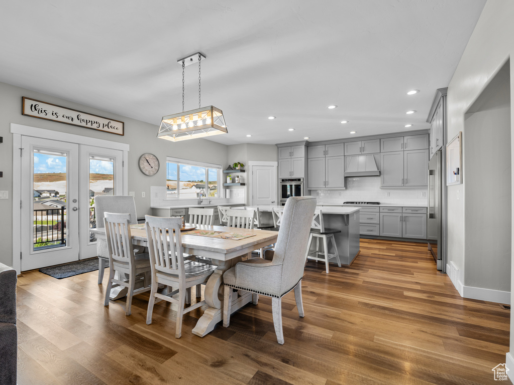 Dining area featuring wood finished floors, recessed lighting, and french doors