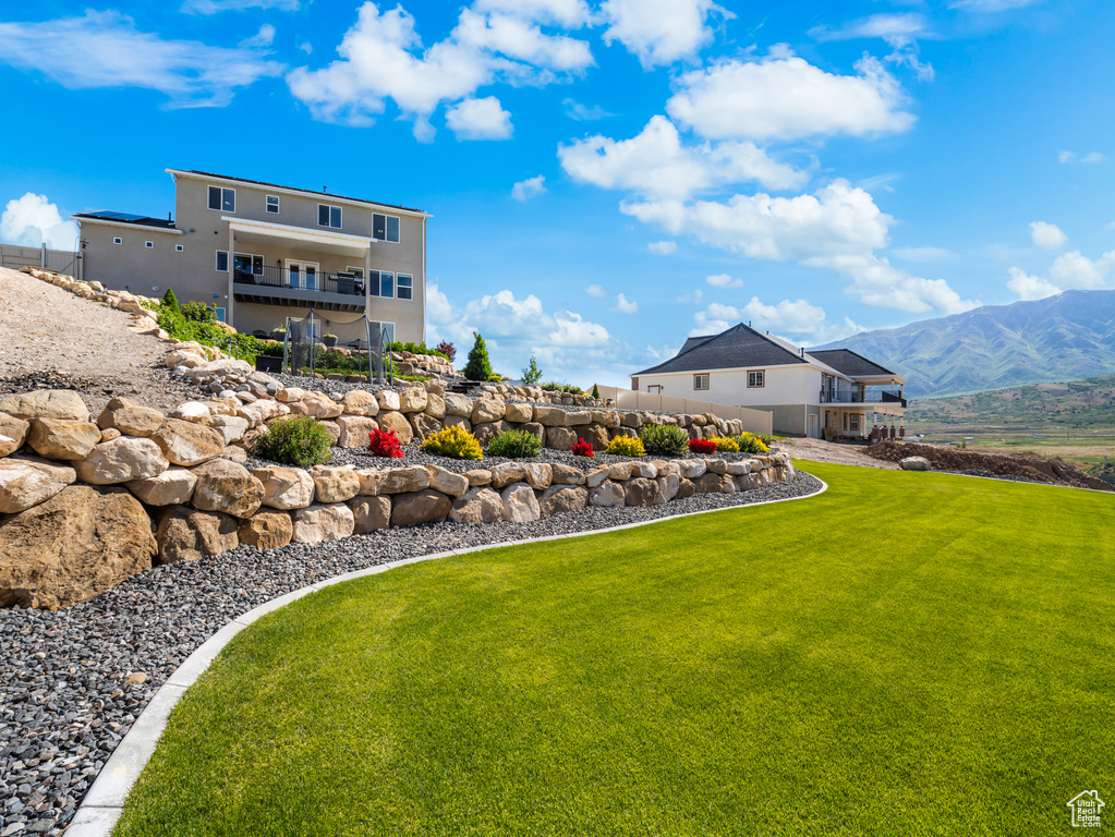 View of green lawn featuring a mountain view