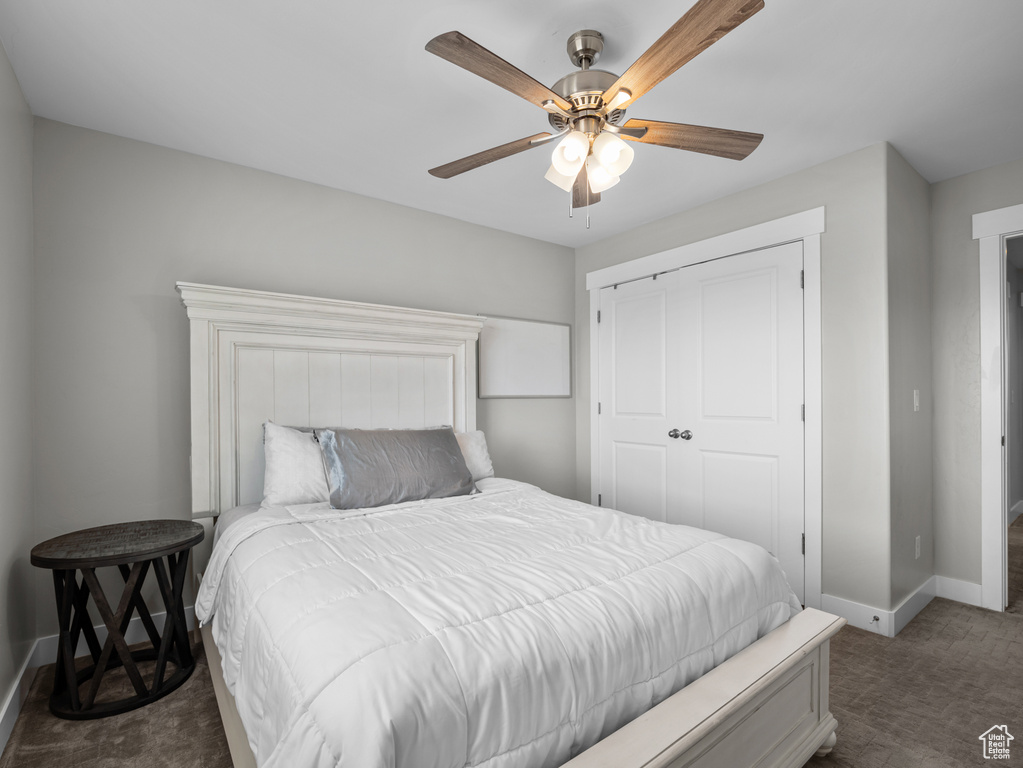 Bedroom with carpet flooring, baseboards, a closet, and a ceiling fan