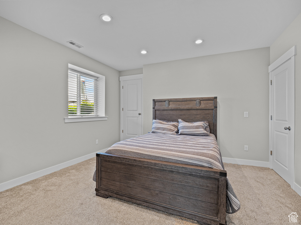 Carpeted bedroom with baseboards and recessed lighting