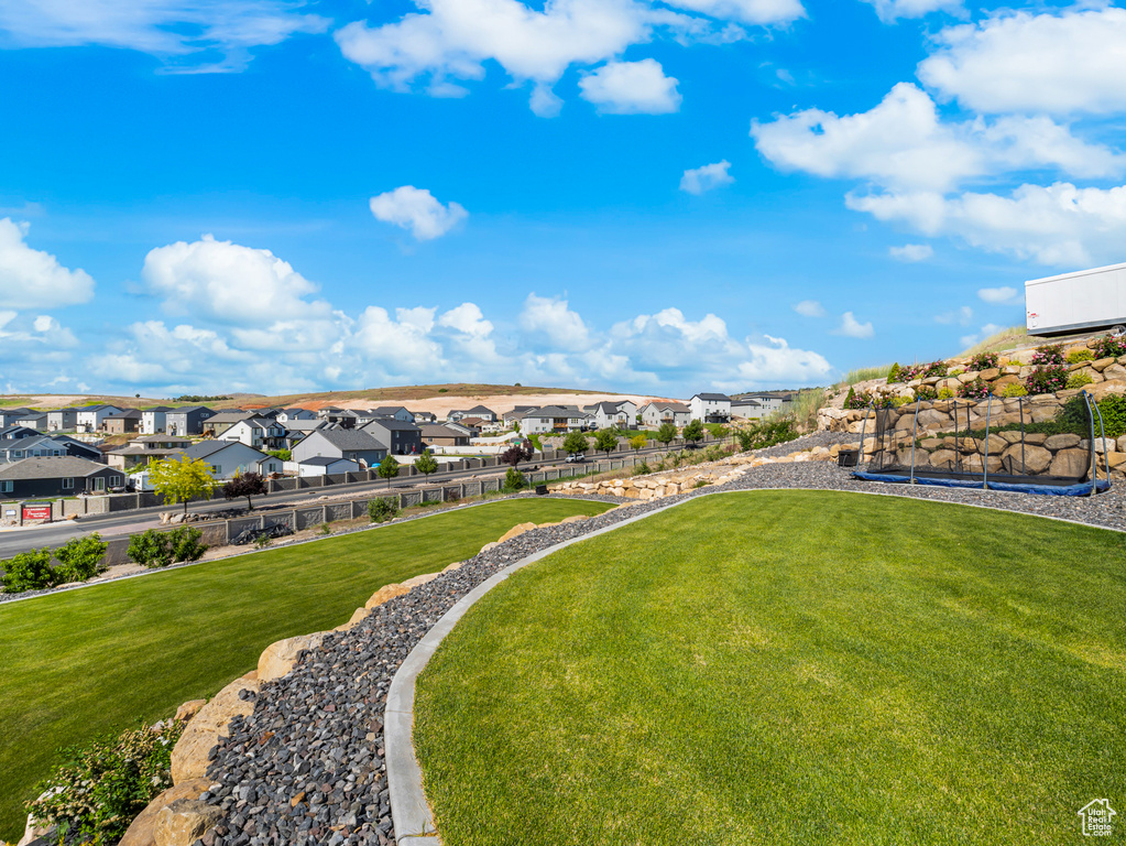 View of community featuring a residential view and a yard