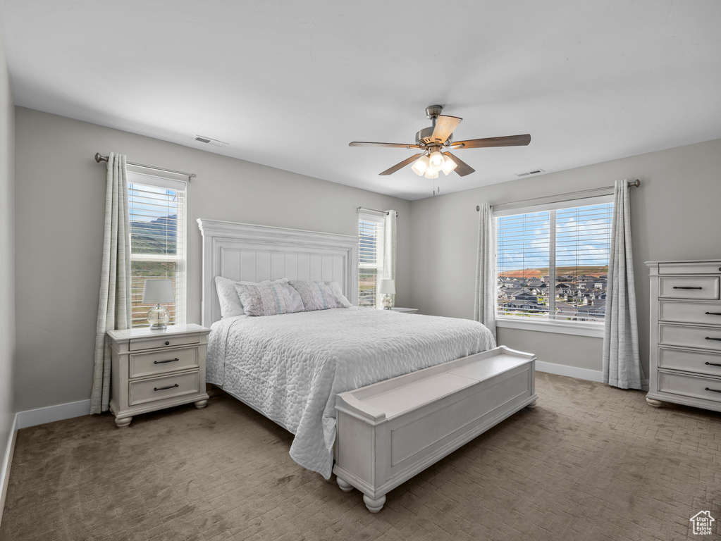 Bedroom featuring baseboards, carpet flooring, and a ceiling fan