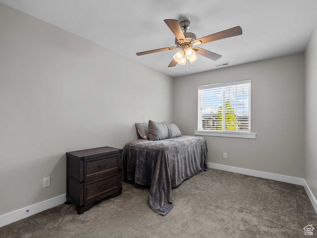 Bedroom with light carpet, baseboards, and ceiling fan